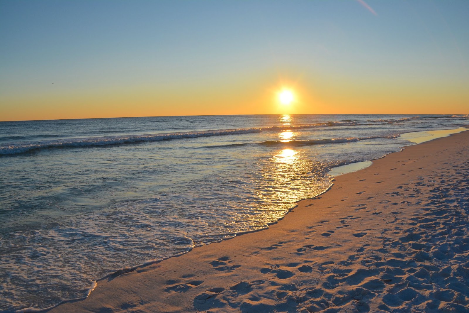 destin-sunset-2023-11-27-05-10-23-utc This is a stunning sunset view over the beach in Destin, Florida, with vibrant colors reflecting on the tranquil waters.