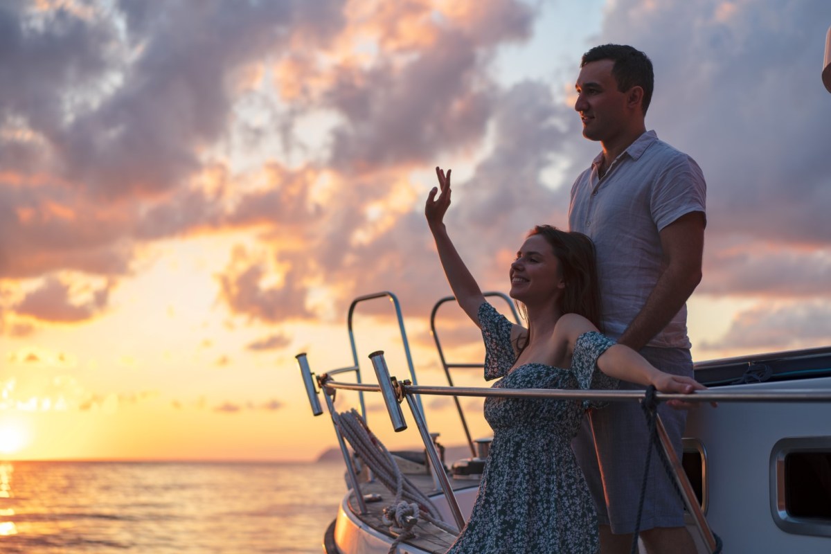 Loving couple spending time on a yacht at the sea a person riding on the back of a boat