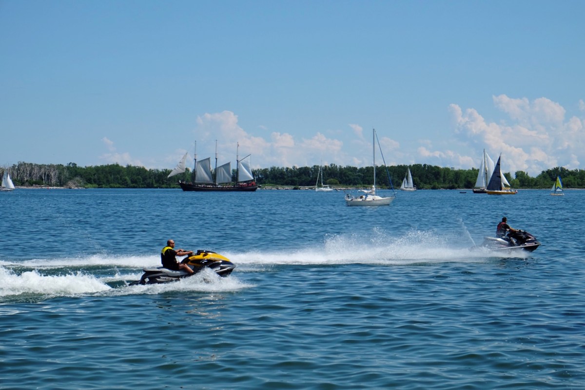 water-motorcycles-yachts-on-the-lake-2023-11-27-05-11-29-utc (Large) a small boat in a body of water