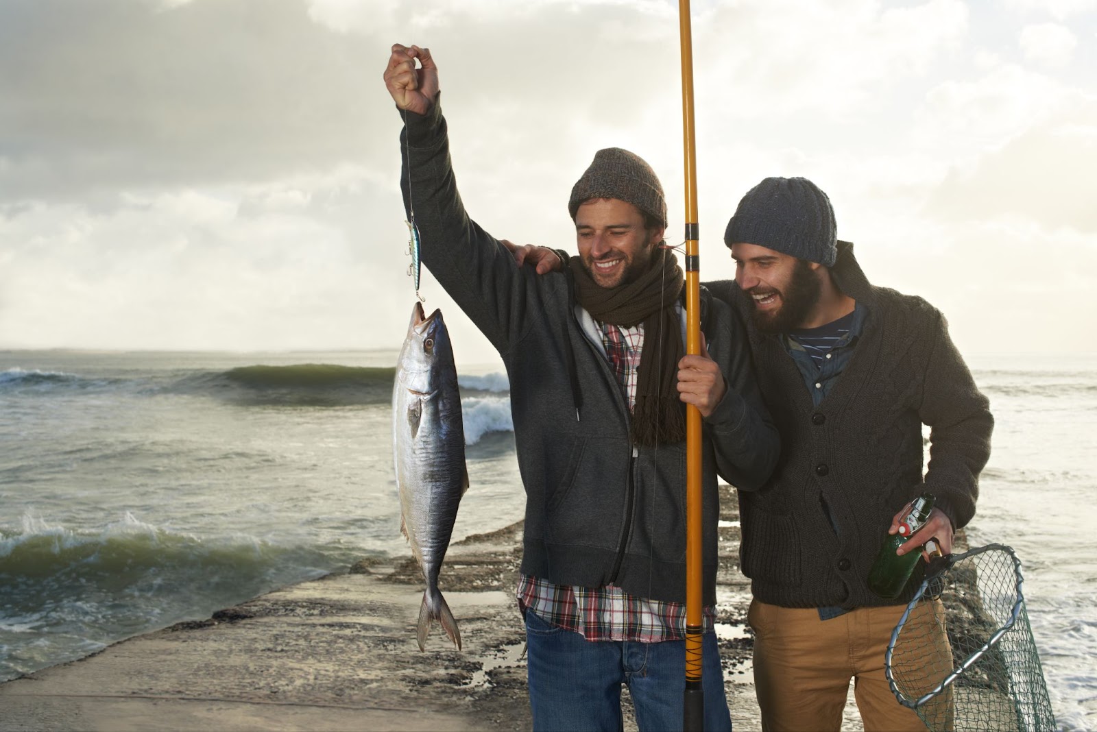 memories-that-will-last-forever-shot-of-two-young-2023-11-27-04-57-39-utc Two men are happy to catch a big fish at the beach.
