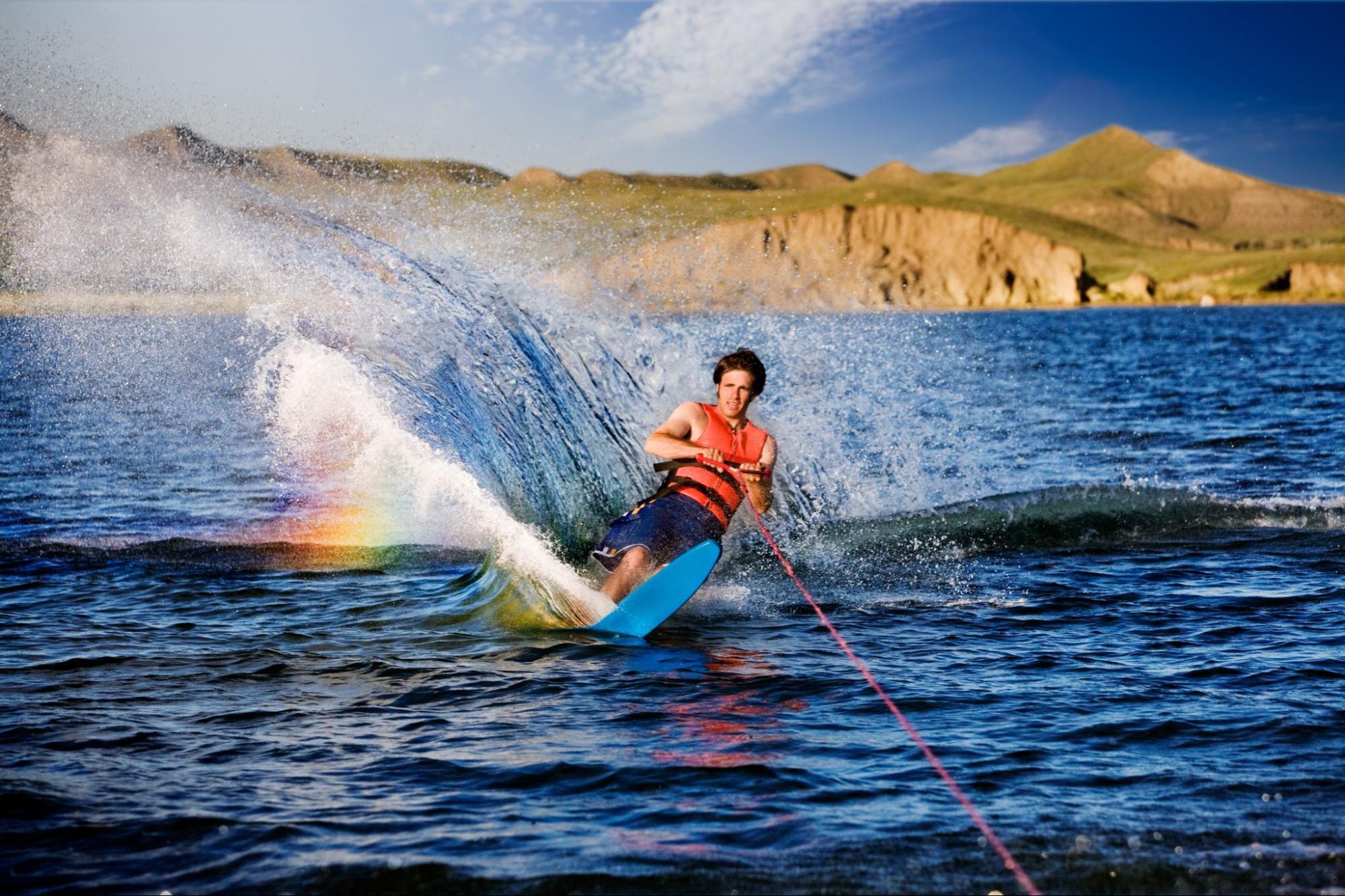 A man water skiing across a lake.