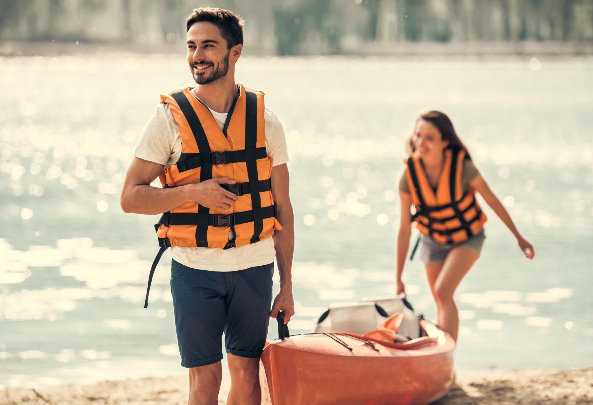 Man and a woman wearing lifejackets. 